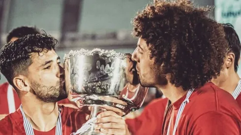 Peluca Falcón besando la copa de campeón de Uruguay.