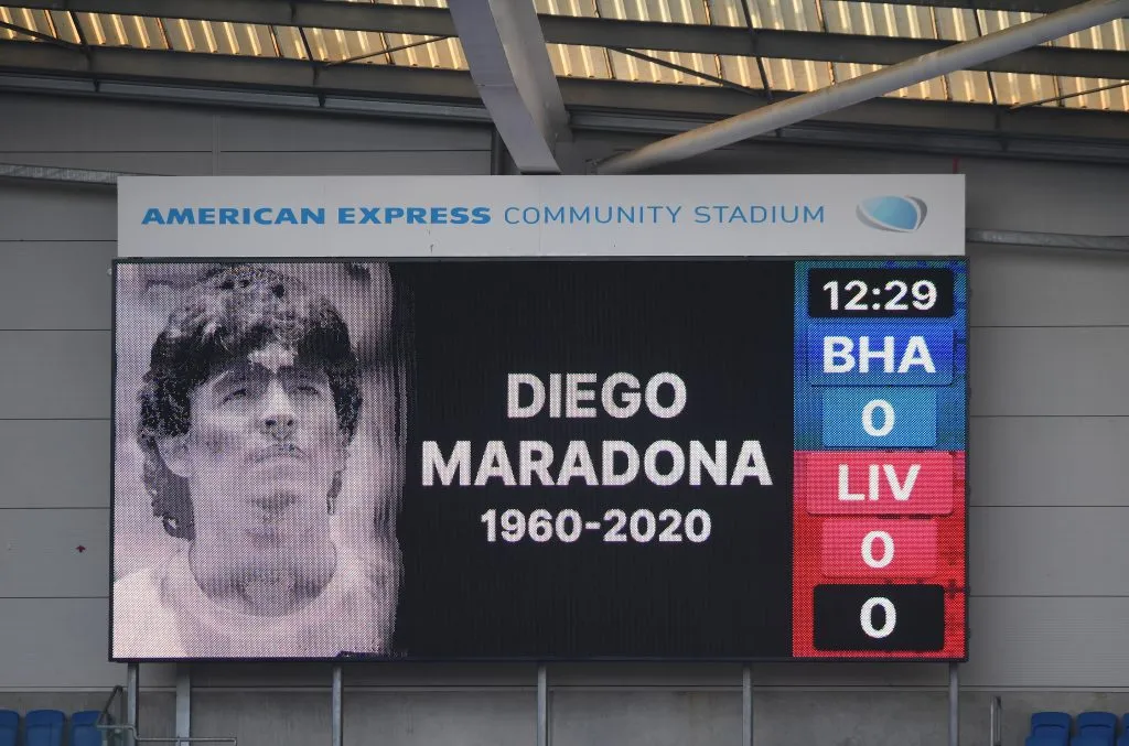 BRIGHTON, ENGLAND – NOVEMBER 28: The big screen displays a picture in memory of Diego Maradona prior to the Premier League match between Brighton &amp; Hove Albion and Liverpool at American Express Community Stadium on November 28, 2020 in Brighton, England. Sporting stadiums around the UK remain under strict restrictions due to the Coronavirus Pandemic as Government social distancing laws prohibit fans inside venues resulting in games being played behind closed doors. (Photo by Mike Hewitt/Getty Images)