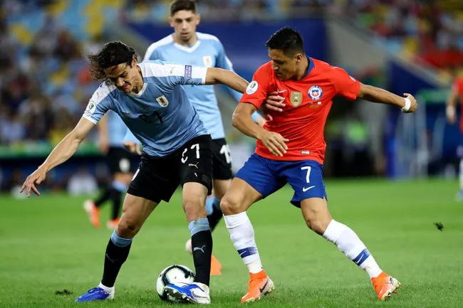 Edinson Cavani ante Alexis Sánchez en la Copa América 2021. (Bruna Prado/Getty Images).