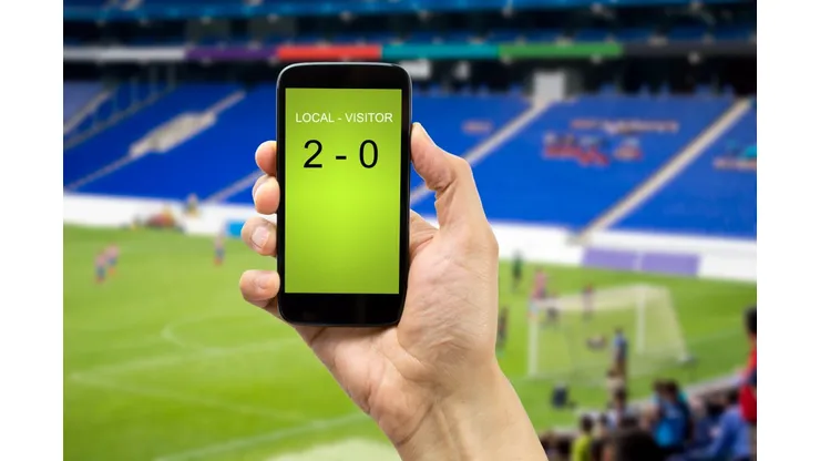 betting man through his smart phone in a stadium