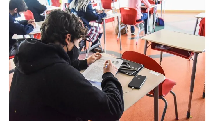 Estudiantes al interior de una sala de clases.
