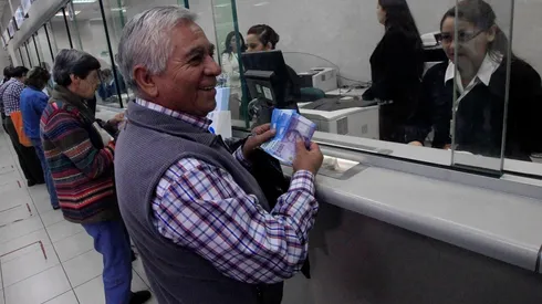 Pensionado cobrando su aguinaldo de navidad en las oficinas del IPS