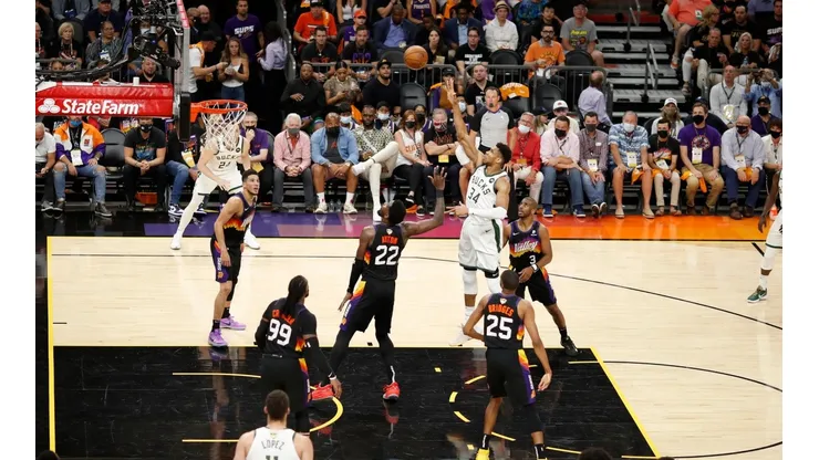 Antetokounmpo anotando al frente de Deandre Ayton