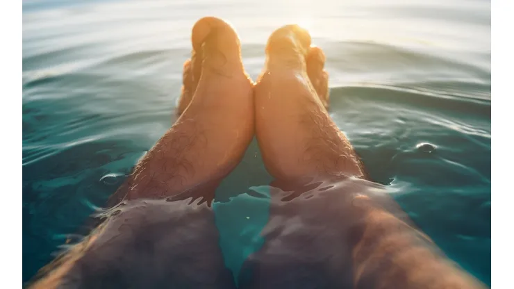 Male feet in outdoor swimming pool