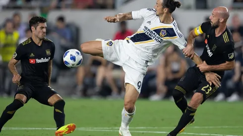 Los Angeles Galaxy forward Zlatan Ibrahimovic (9) fights for the ball against Los Angeles FC midfielder Benny Feilhaber (33) and defender Laurent Ciman (23) during the first half of a Major League Soccer match at Banc of California Stadium in Los Angeles, Calif. on Thursday July 26, 2018. (Photo by Raul Romero Jr, Contributing Photographer)