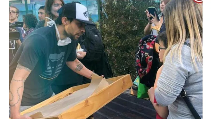 Valdivia reparte empanadas a la gente que espera micro.