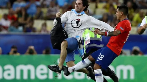 Gonzalo Jara frenando al hincha que entró a la cancha (Foto: Getty Images)