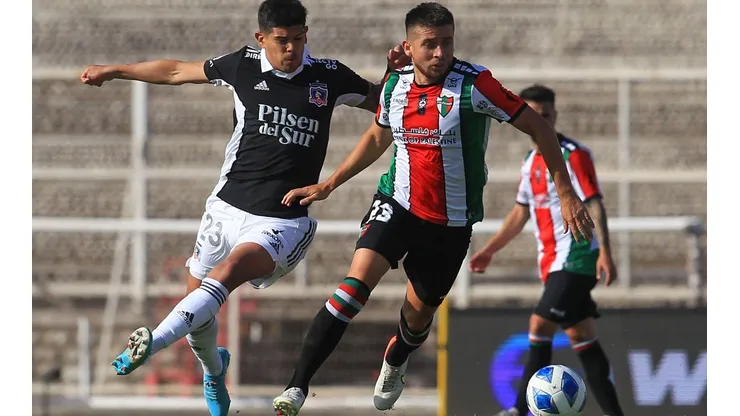Ariel Martínez disputa un balón con Esteban Pavez en un duelo de Colo Colo y Palestino en La Cisterna.