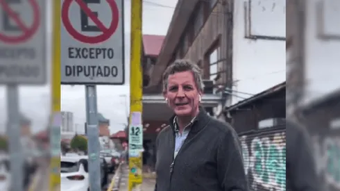 El diputado Gonzalo de la Carrera y el cartel de la polémica.