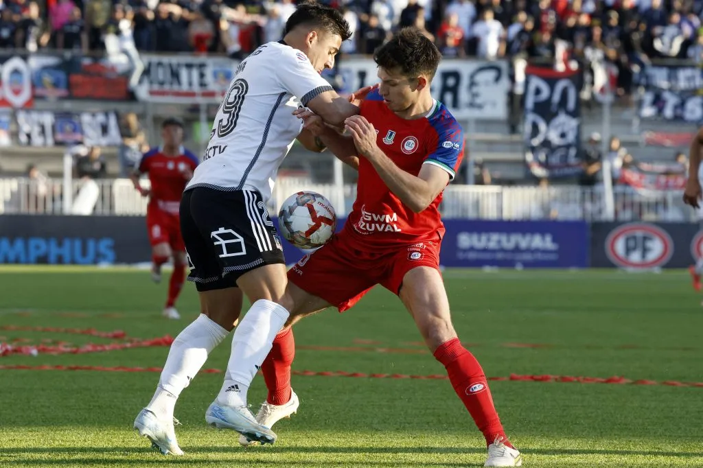 Enzo Ferrario lucha un balón ante Guillermo Paiva, paraguayo ex Colo Colo. (Martin Thomas/Photosport).