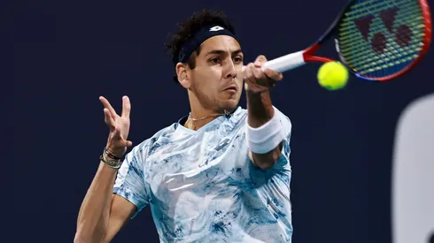 Alejandro Tabilo returns a shot against Casper Ruud at 2025 Miami Open