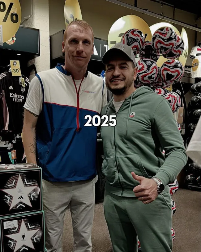 Jeremy Mathieu se saca una foto con un hincha mientras trabaja en una tienda de ropa.