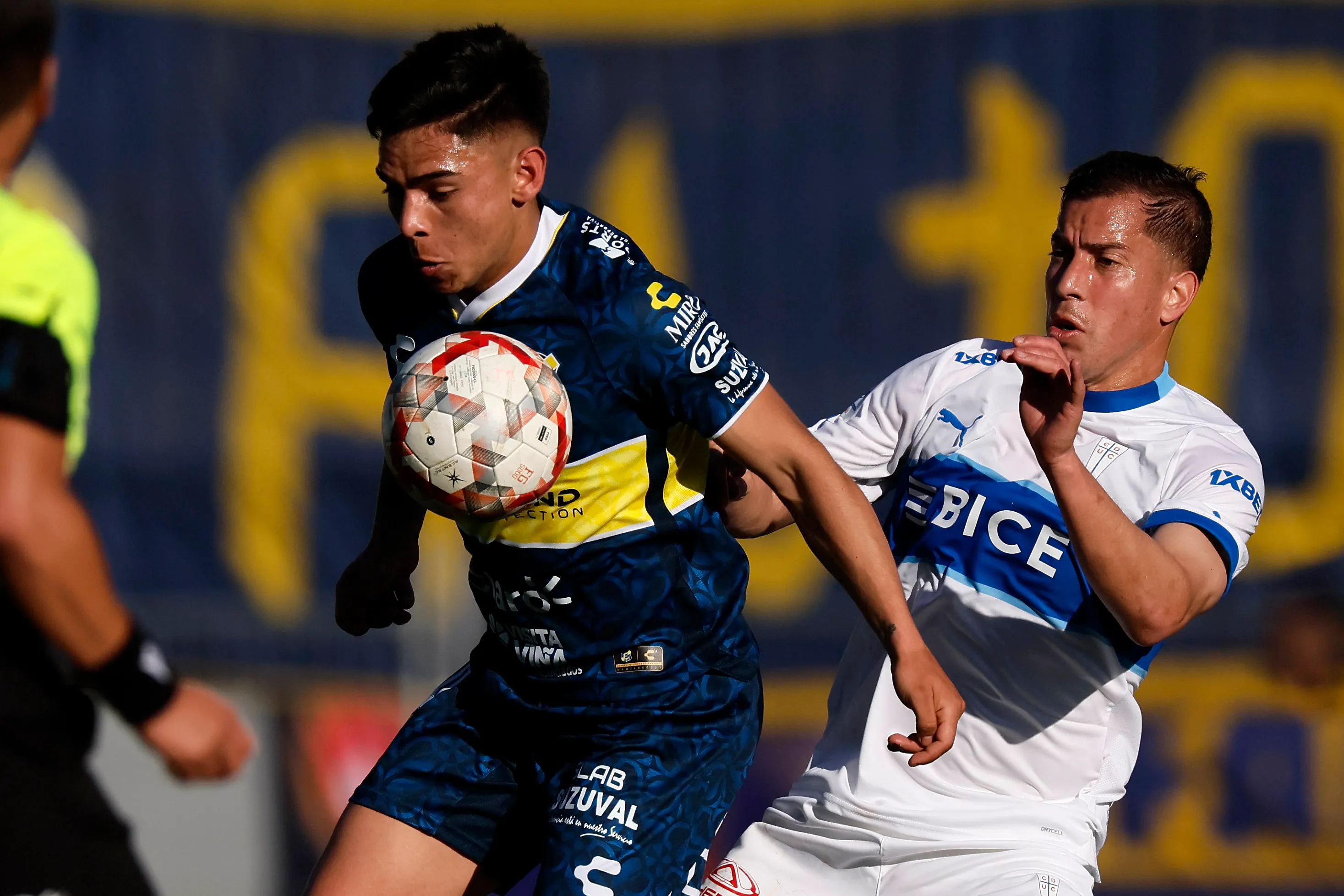 Joan Cruz aguanta la marca de Agustín Farías en un duelo entre Everton y la Católica. (Andres Pina/Photosport).