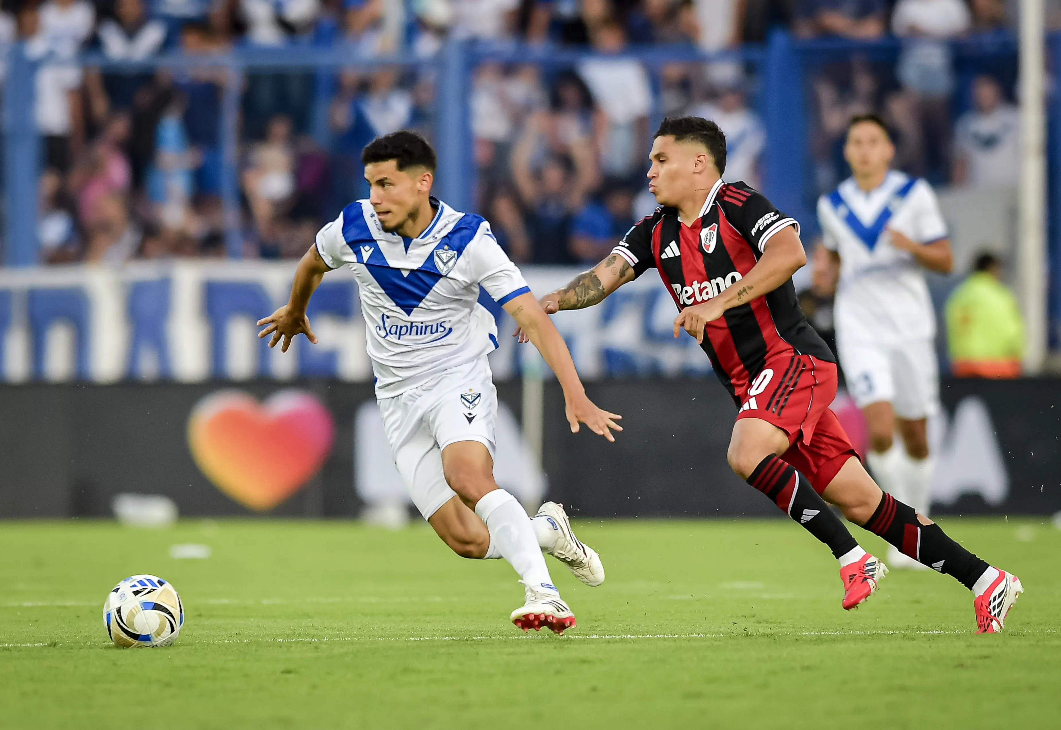 Lucas Robertone se escabulle de Juanfer Quintero. (Marcelo Endelli/Getty Images).