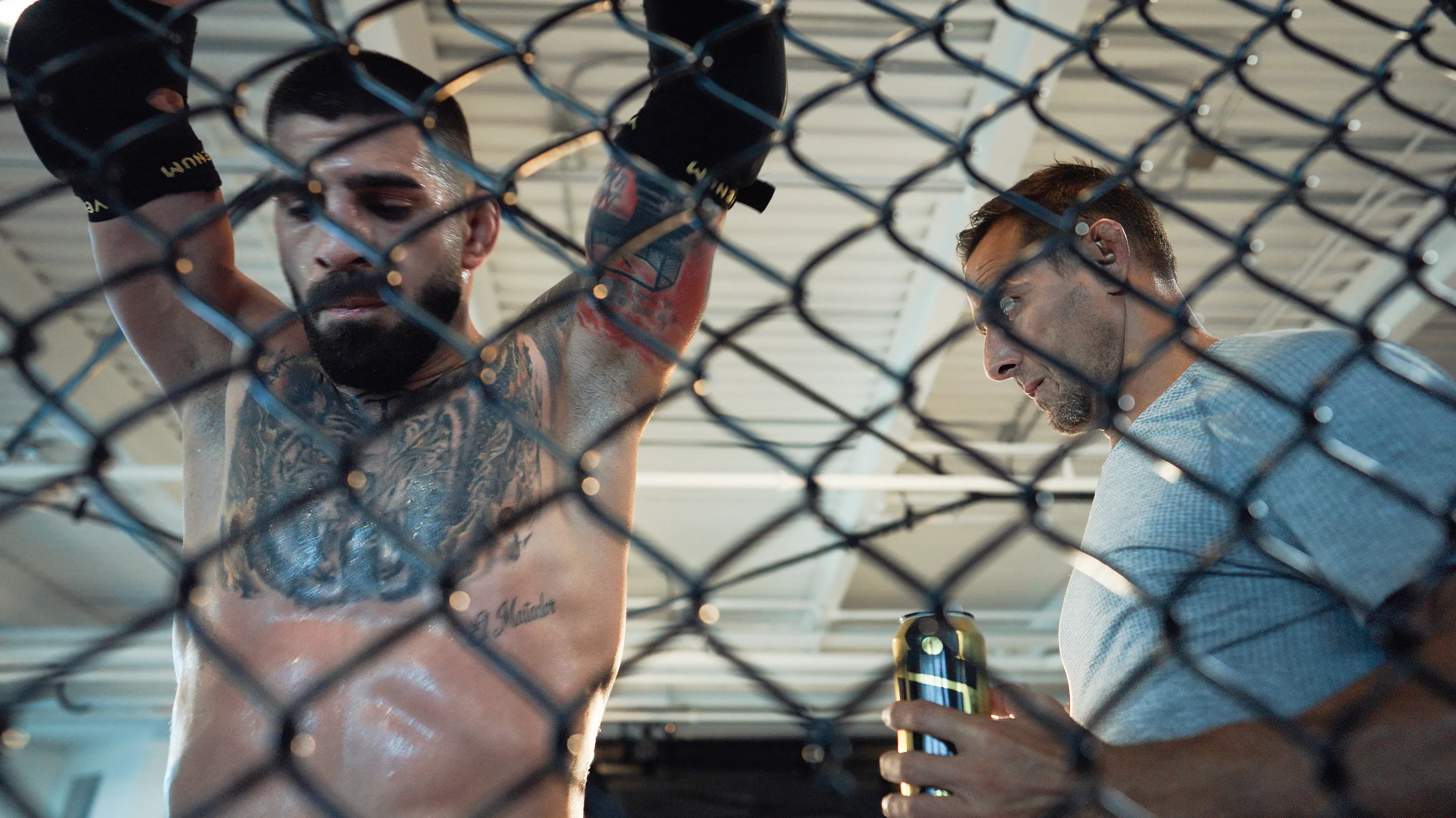 Ilia Topuria is resting from a sparring session while Jesús Gallo, Physical Trainer, is drinking an energy drink before “UFC 317: Topuria vs Oliveira”
