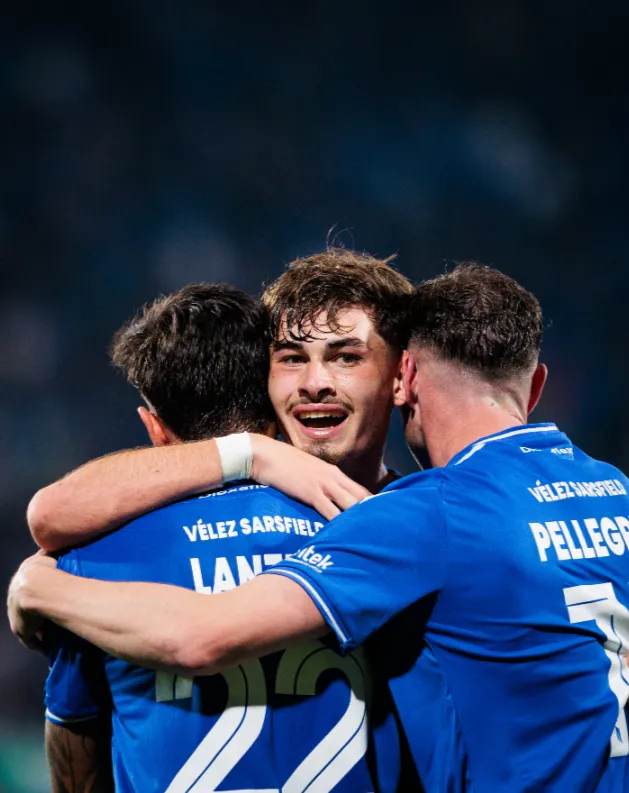 Manuel Lanzini y Matías Pellegrini abrazan a Juan Cruz Policella. (Foto: Vélez).